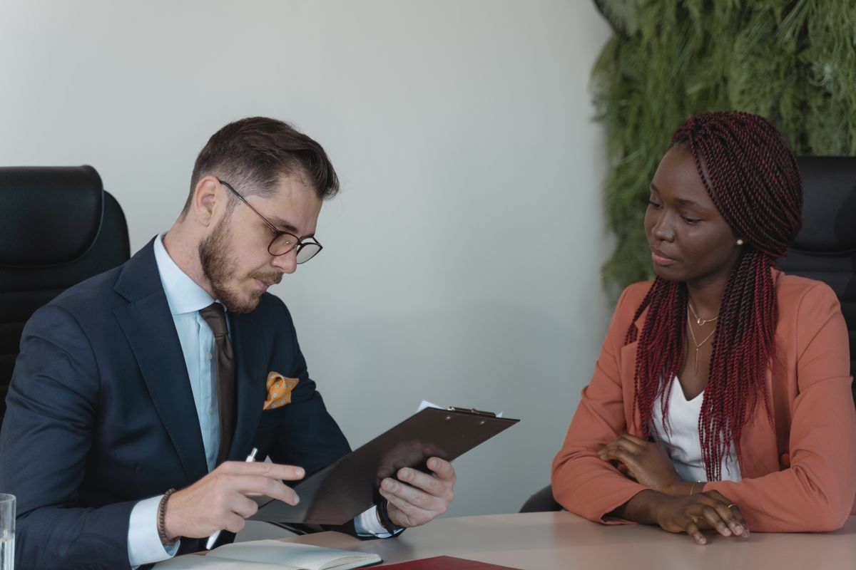 Two professionals reviewing career documents together at a desk