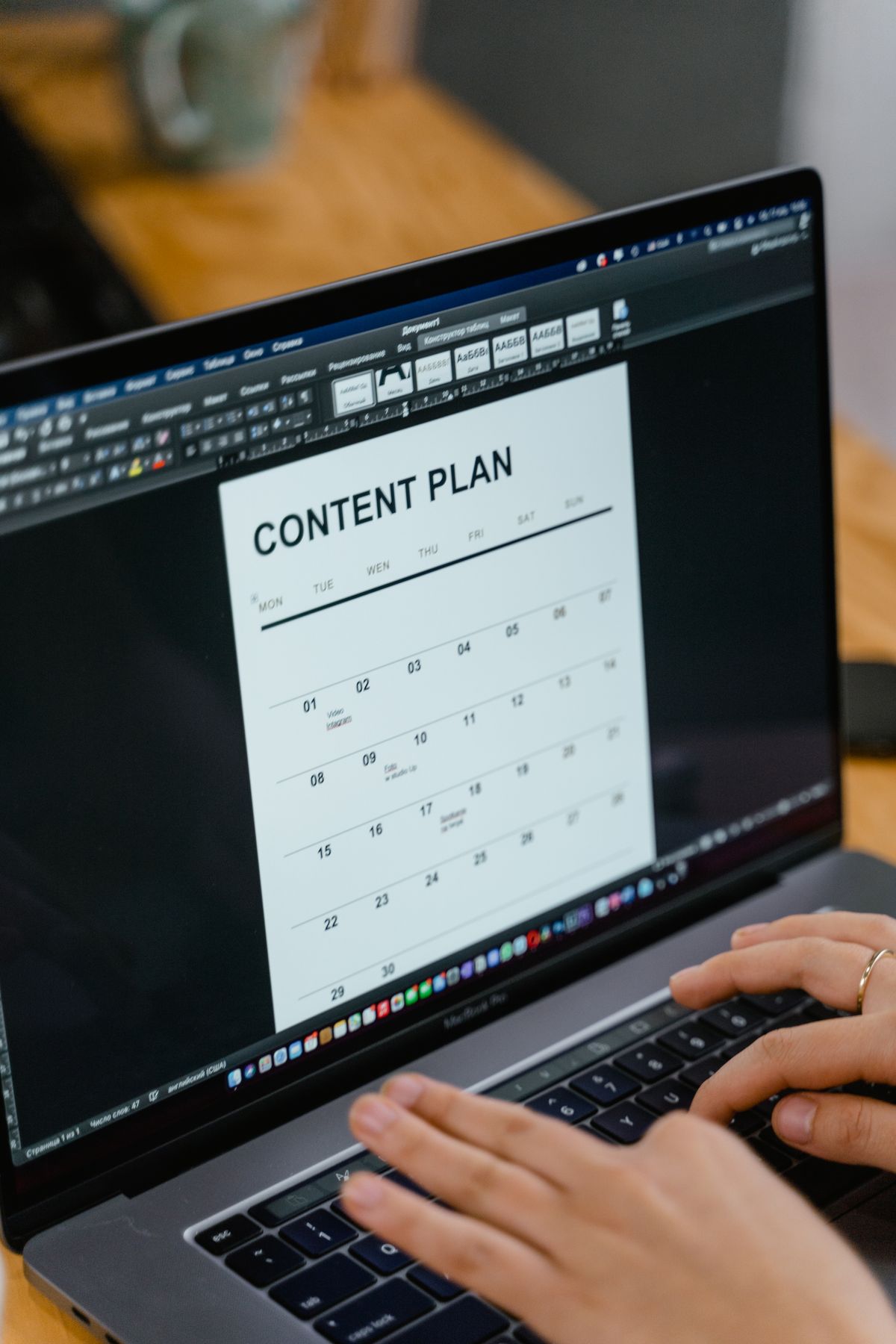 A person organizing a content plan on a laptop