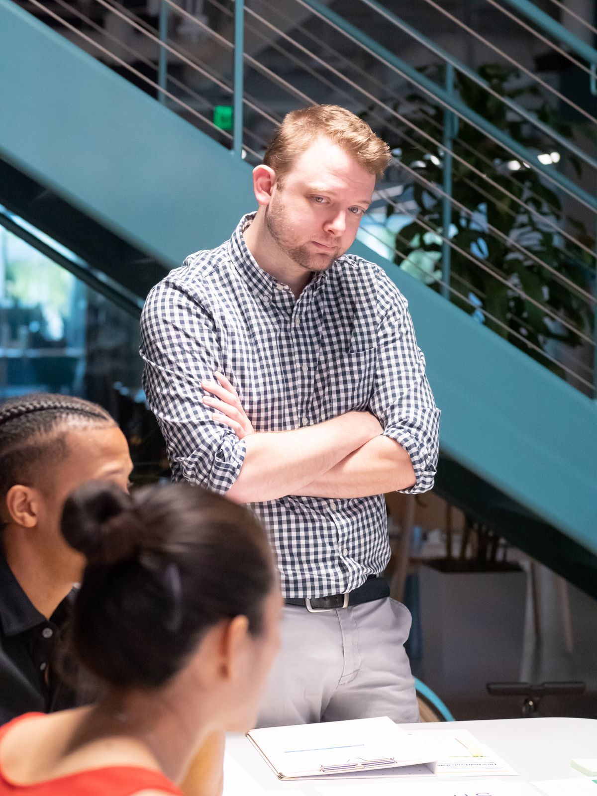 A manager listening to colleagues during a team discussion