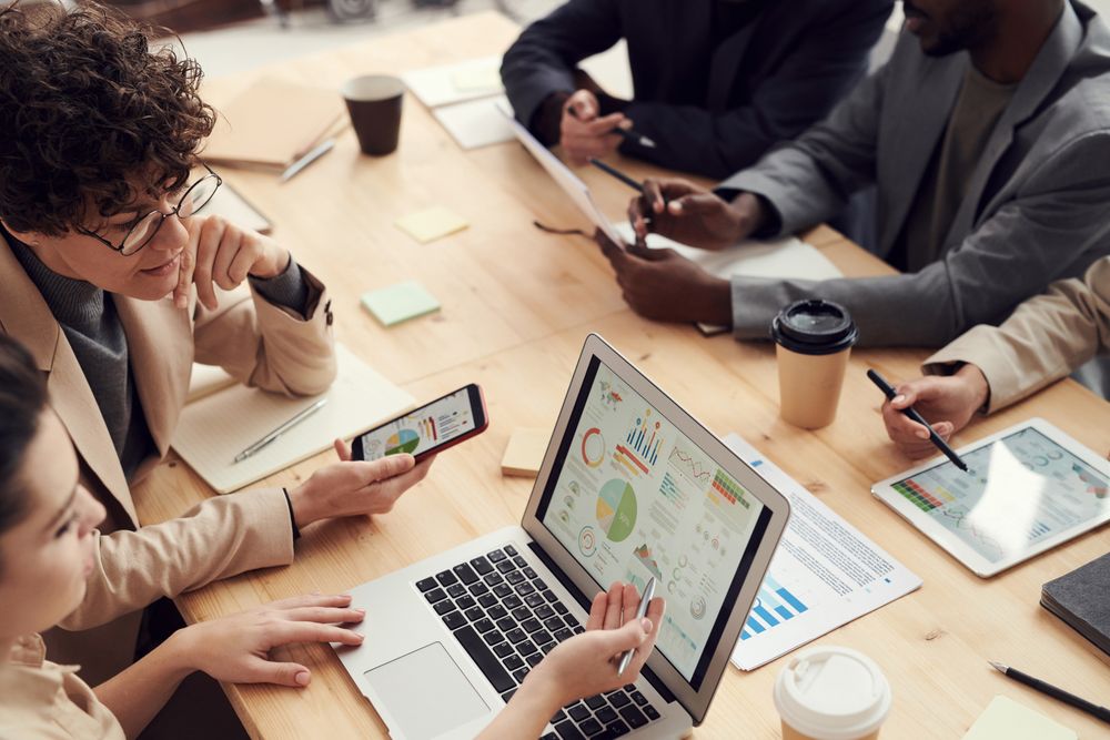 Professionals reviewing charts and notes together to understand a business problem